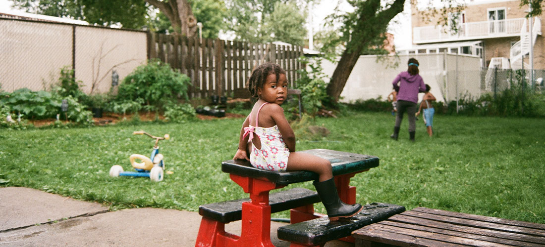 African American sitting on a red picnic table