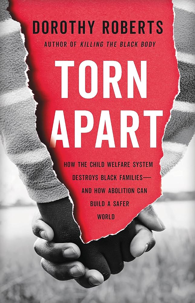 Book cover of Torn Apart by Dorothy Roberts shows a black and white image of hands holding with a ripped paper effect down the center.