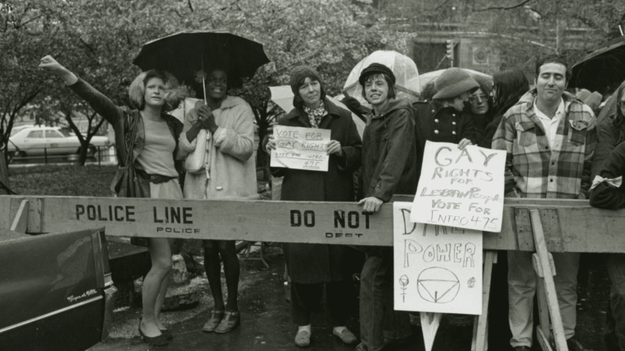 Marsha P. Johnson and Sylvia Rivera stand behind a police baracade in protest.