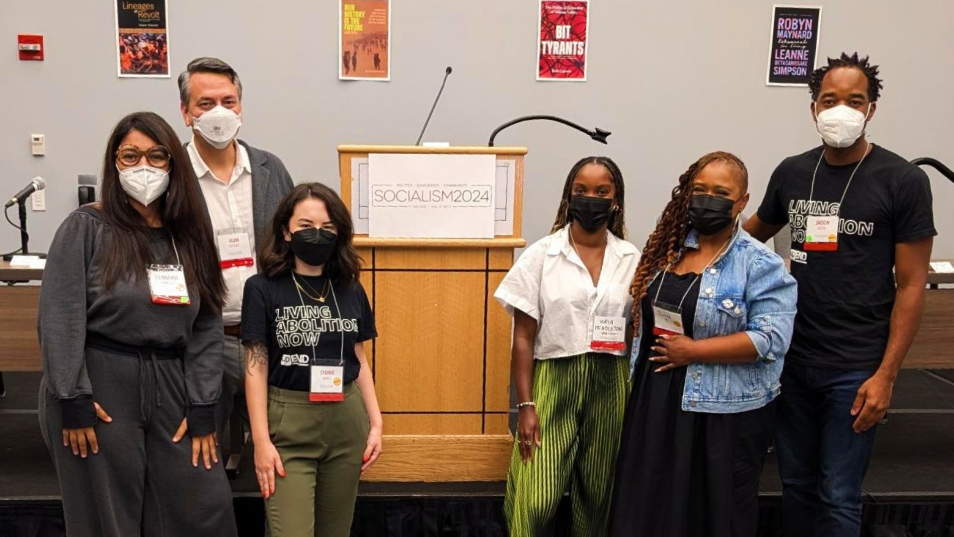 The upEND team wears masks and takes a group photo at Socialism Conference 2024.