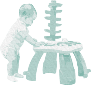 A toddler plays with a puzzle table. 