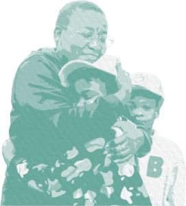 A grandmother hugs two grandsons wearing baseball caps.