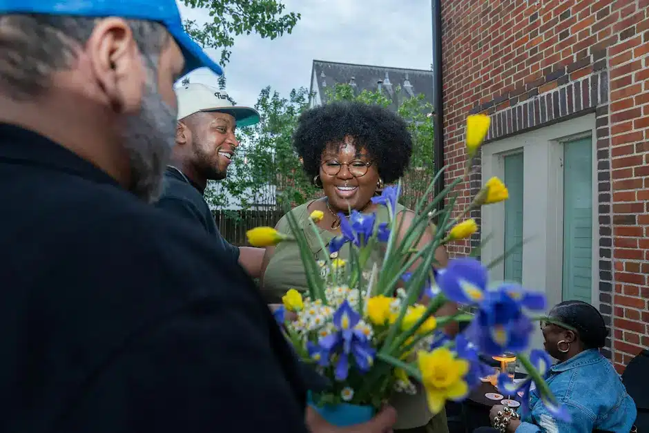 A woman receives a bouquet of flowers at an event in Third Ward, Houston.